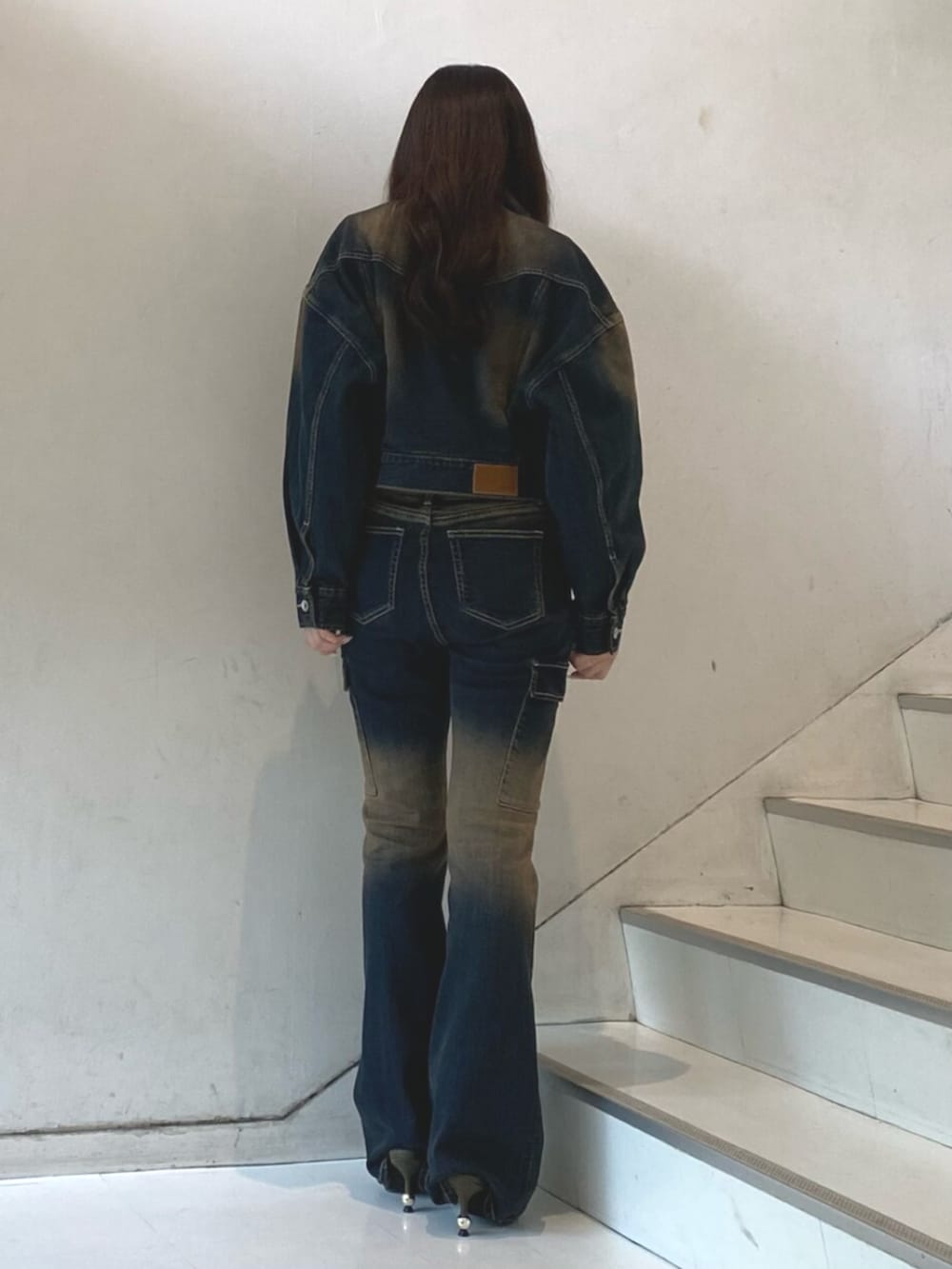 ブルー系のデニムジャケット、ブルー系のデニムパンツ、ホワイト系のTシャツ/カットソーを着用したレディースの秋コーディネートの3枚目の写真