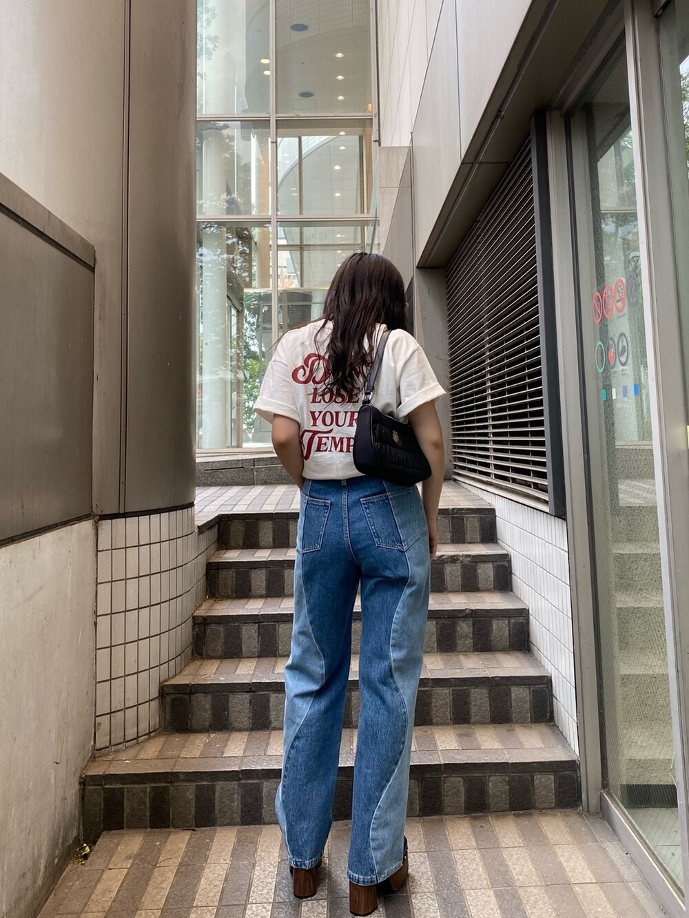 ホワイト系のTシャツ/カットソー、ブルー系のデニムパンツ、ブラック系のサンダルを着用したレディースの夏コーディネートの3枚目の写真