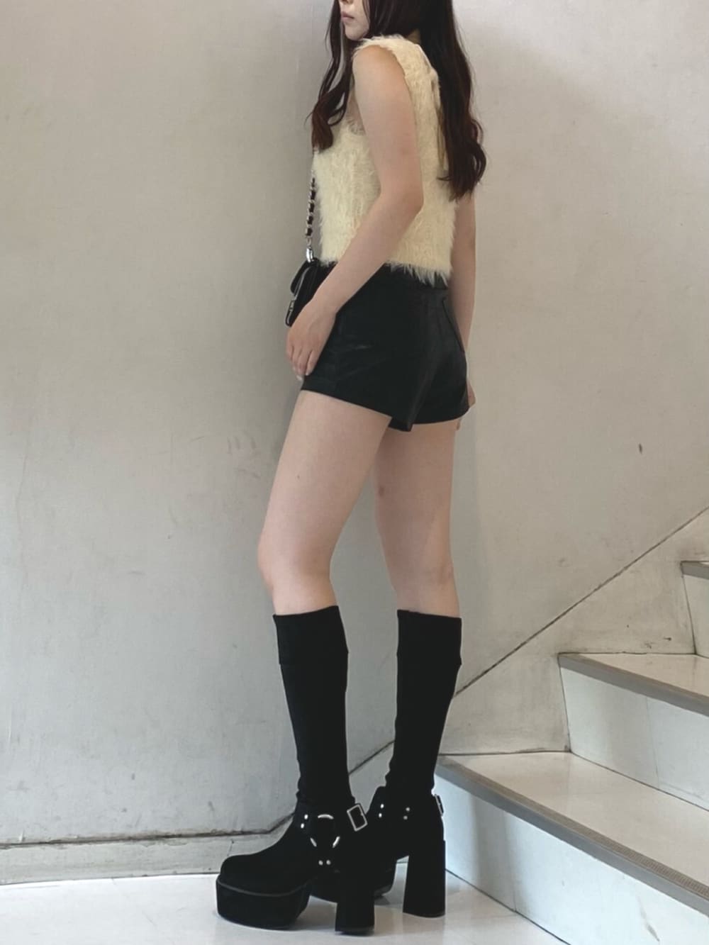 ホワイト系のタンクトップ、ブラック系のその他パンツ、ブラック系のブーツを着用したレディースの秋コーディネートの2枚目の写真