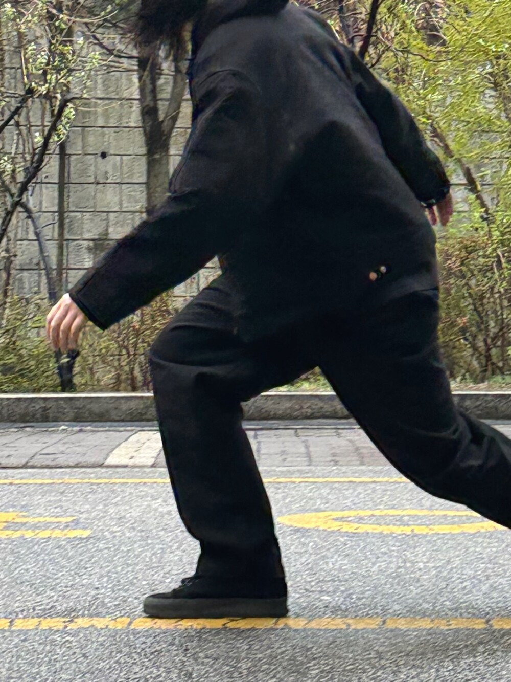 ブラック系のチノパンツ、ブラック系のブルゾン、ブラック系のスニーカーを着用したメンズの春コーディネートの2枚目の写真