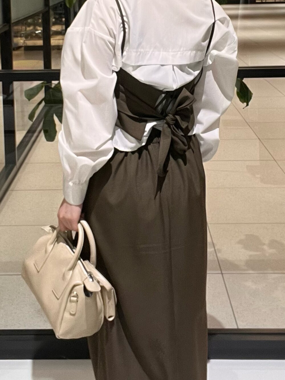 ホワイト系のシャツ/ブラウス、ブラウン系のその他トップス、ブラウン系のスカートを着用したレディースの春コーディネートの2枚目の写真