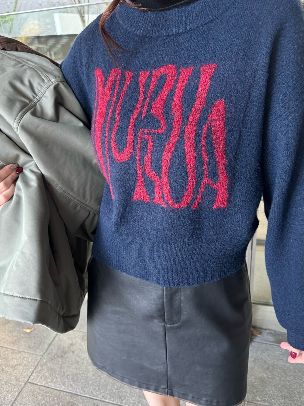 ブルー系のニット/セーター、ブラック系のスカート、ブラック系のブーツを着用したレディースの秋コーディネートの6枚目の写真