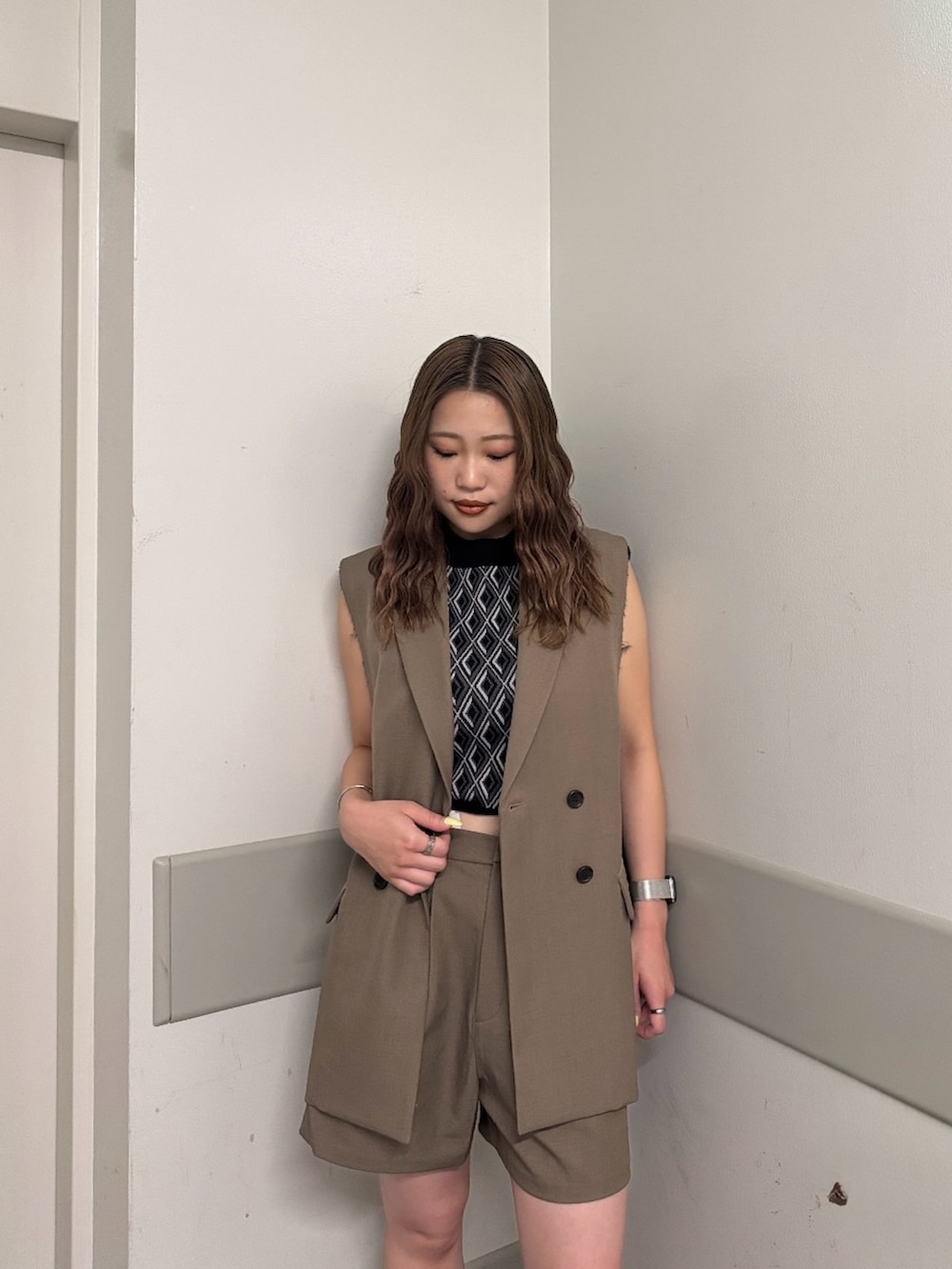 ブラウン系のベスト、ブラック系のタンクトップ、ブラウン系のその他パンツを着用したレディースの夏コーディネートの4枚目の写真