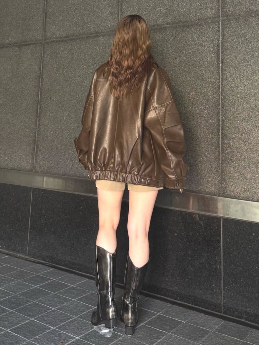 ブラウン系のブーツ、ベージュ系のその他パンツ、ホワイト系のTシャツ/カットソーを着用したレディースの秋コーディネートの3枚目の写真