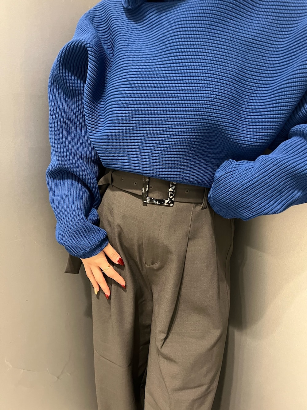 ブルー系のニット/セーター、グレー系のその他パンツを着用したレディースの秋コーディネートの6枚目の写真