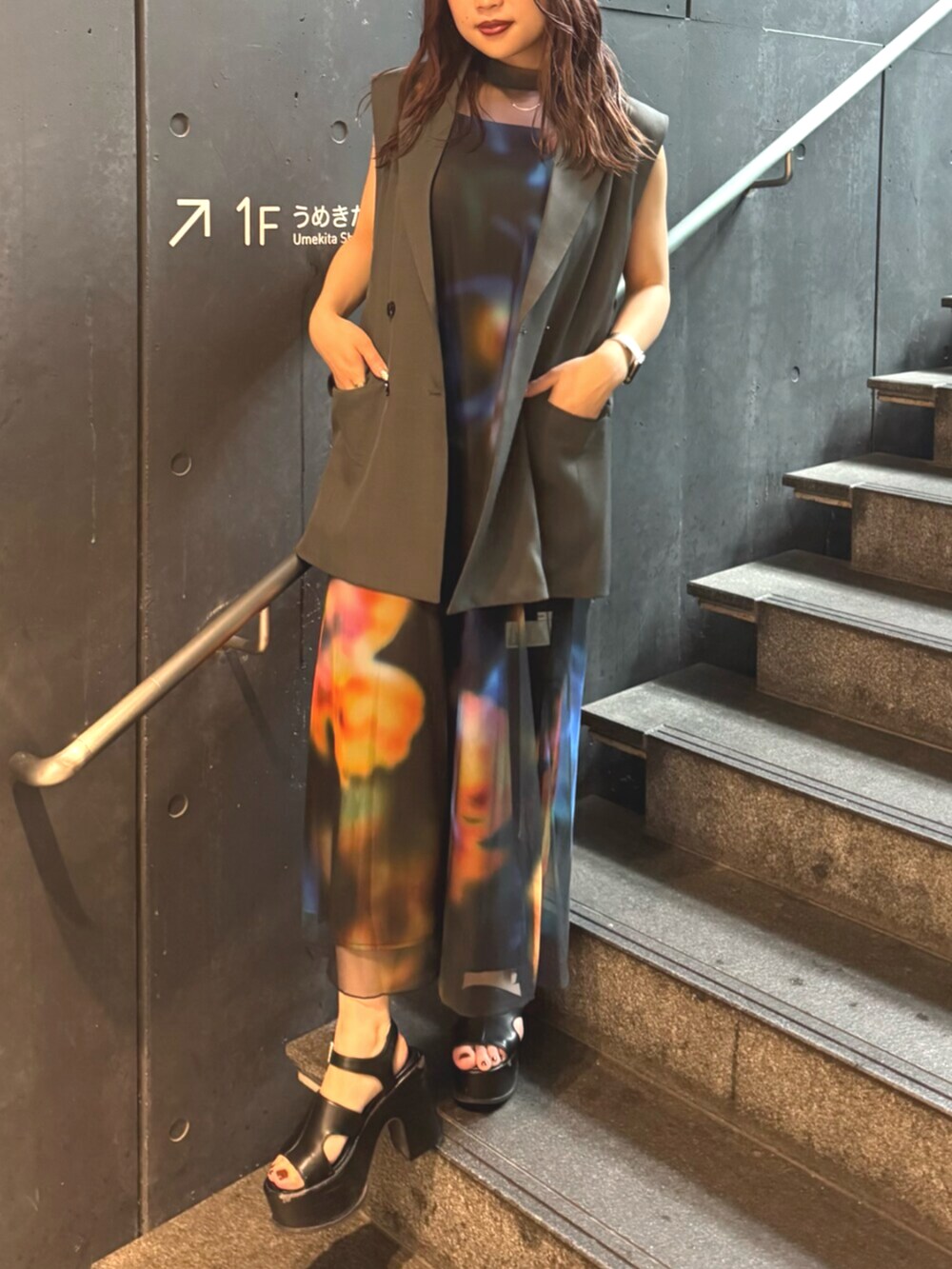 ブラック系のサンダル、グレー系のベスト、ブラック系のワンピースを着用したレディースの夏コーディネートの4枚目の写真