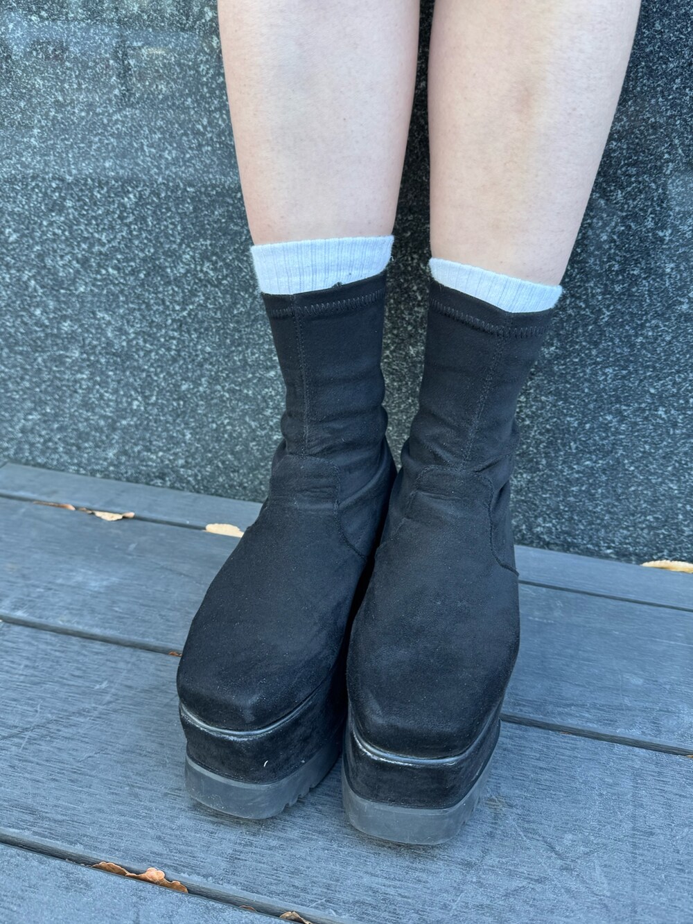 ホワイト系のニット/セーター、ブラウン系のスカート、ブラック系のブーツを着用したレディースの冬コーディネートの7枚目の写真