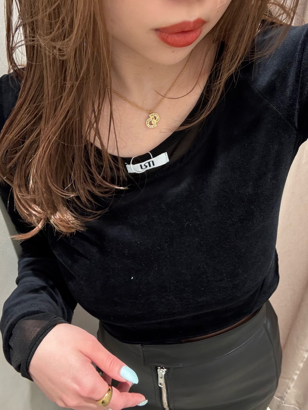 ブラック系のスカート、ブラック系のTシャツ/カットソー、ブラック系のブーツを着用したレディースの冬コーディネートの5枚目の写真