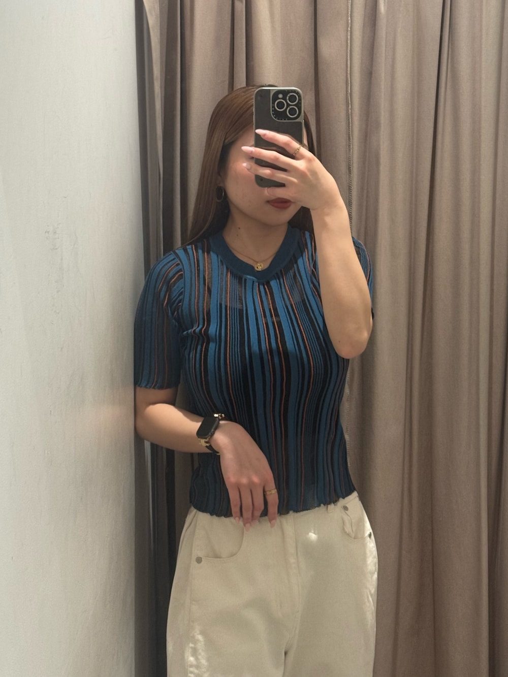 ホワイト系のデニムパンツ、ブルー系のニット/セーター、ブラック系のブーツを着用したレディースの春コーディネートの4枚目の写真