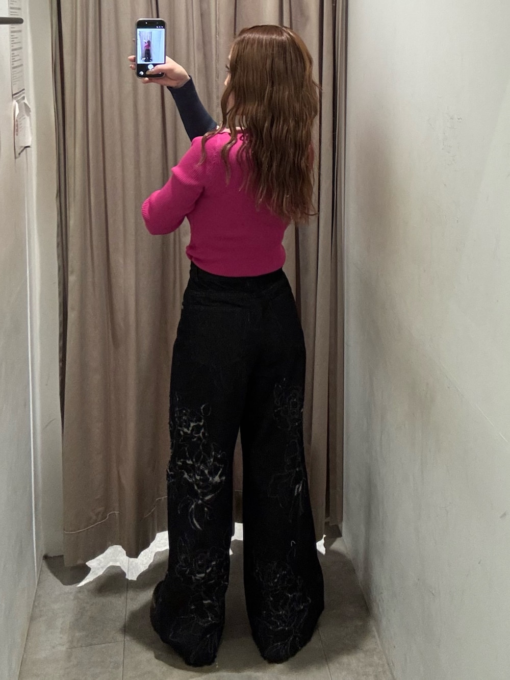 ピンク系のニット/セーター、ブラック系のデニムパンツ、ブラック系のブーツを着用したレディースの冬コーディネートの3枚目の写真