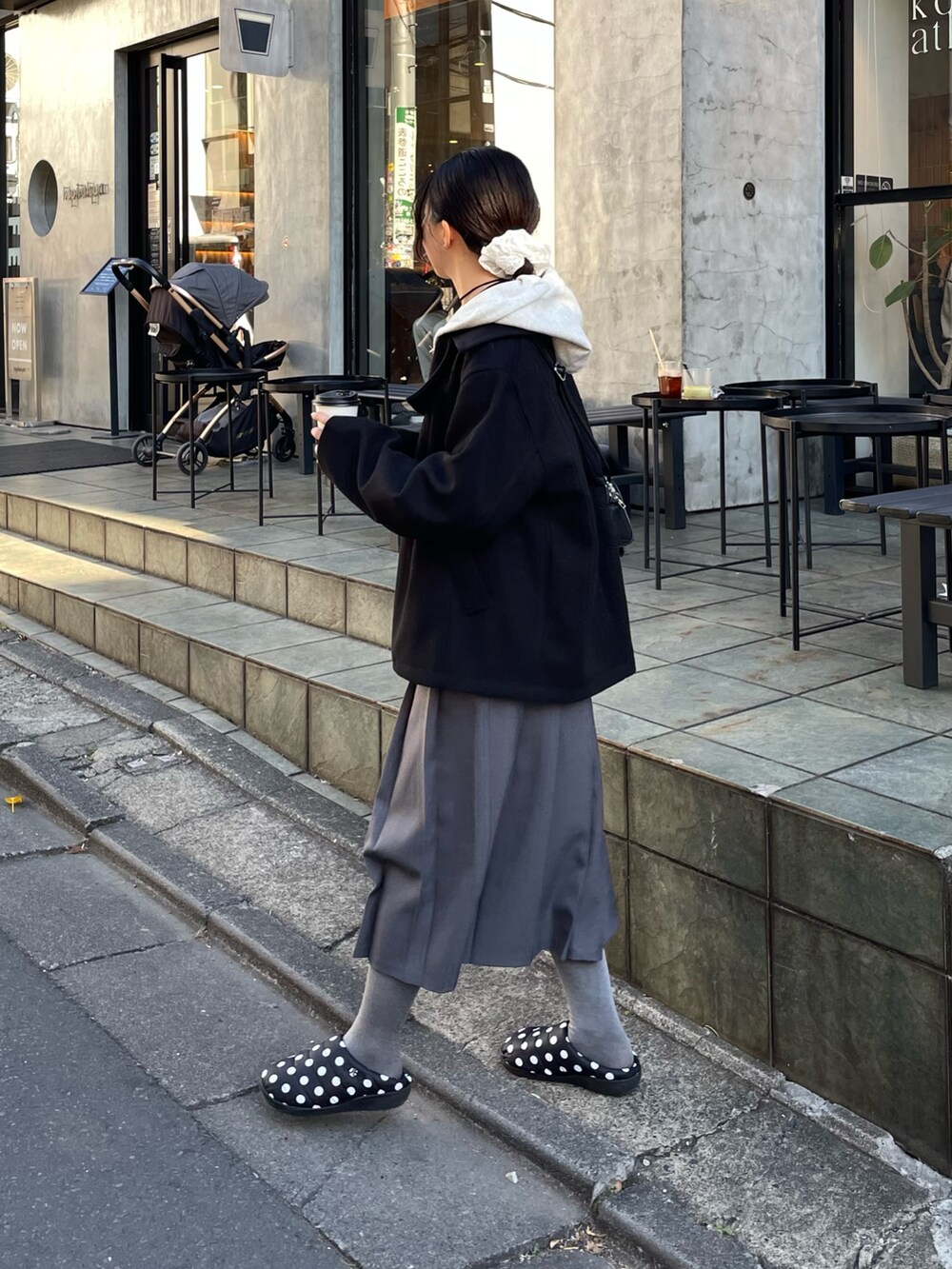 ブラック系のピーコート、ホワイト系のパーカー、ブラック系のボストンバッグを着用したレディースの冬コーディネートの2枚目の写真