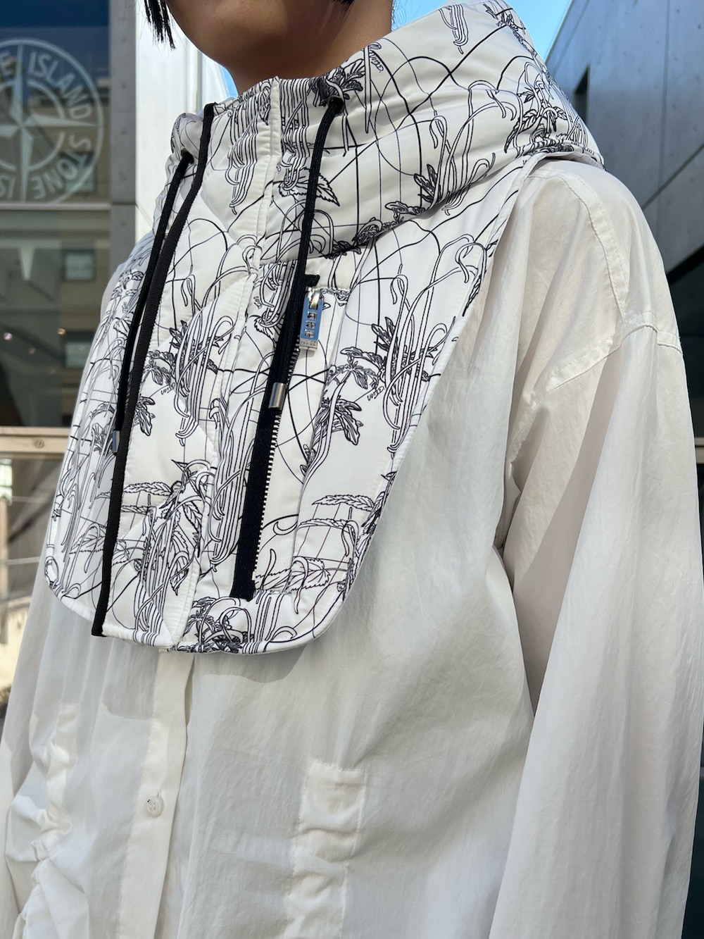 ホワイト系のシャツ/ブラウス、ホワイト系のスカート、ホワイト系のネックウォーマー/スヌードを着用したレディースの秋コーディネートの4枚目の写真