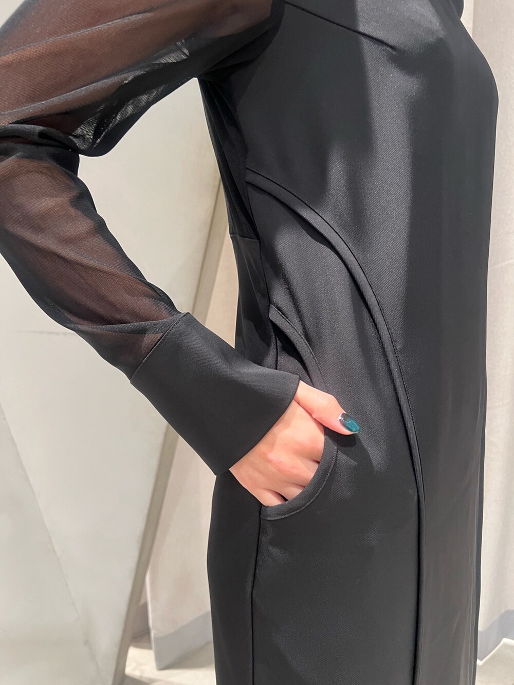 ブラック系のワンピース、その他のショルダーバッグ、ブラック系のブーツを着用したレディースの冬コーディネートの5枚目の写真