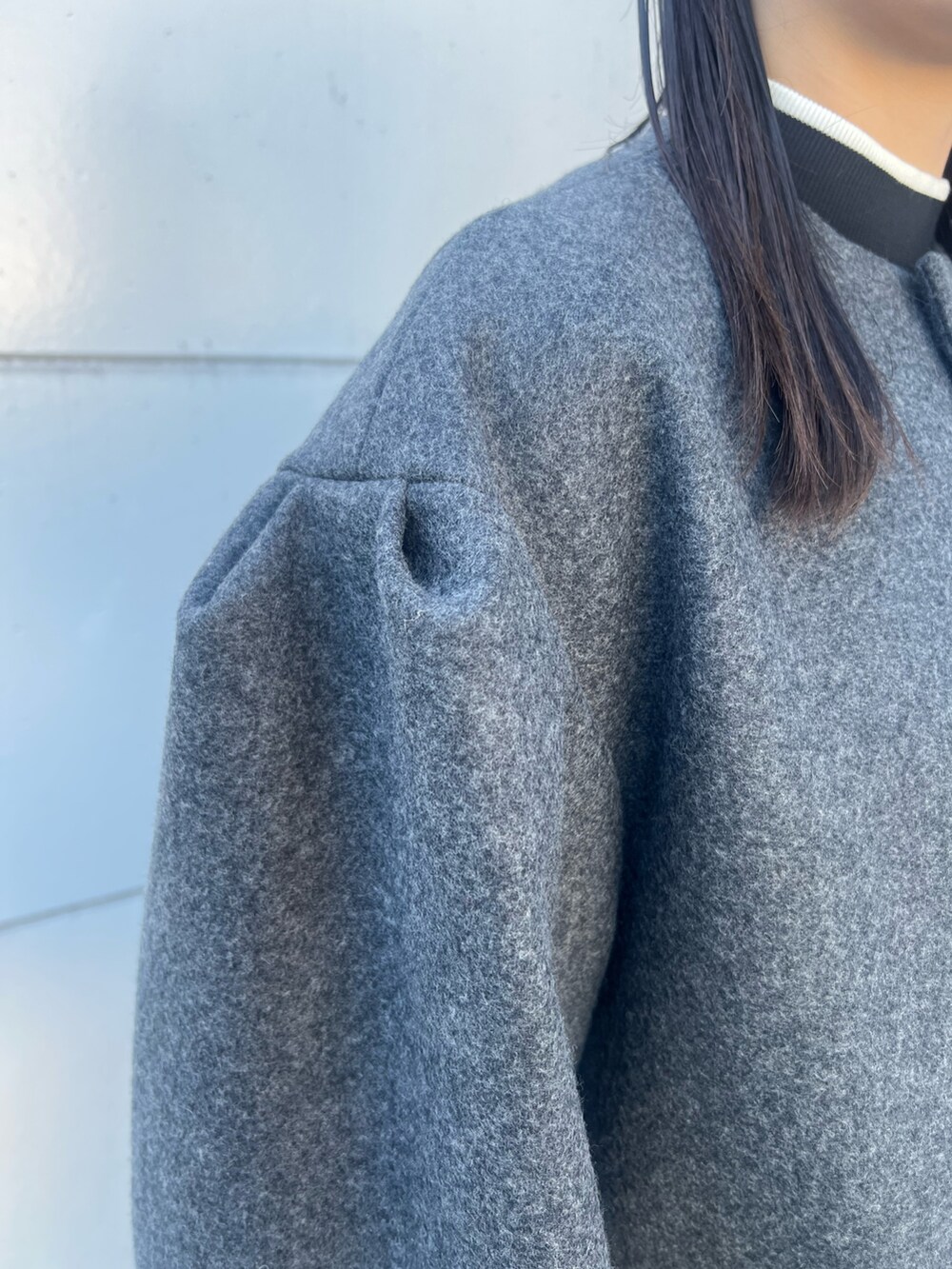 グレー系のその他アウター、ホワイト系のショルダーバッグ、ブラック系のブーツを着用したレディースの冬コーディネートの8枚目の写真