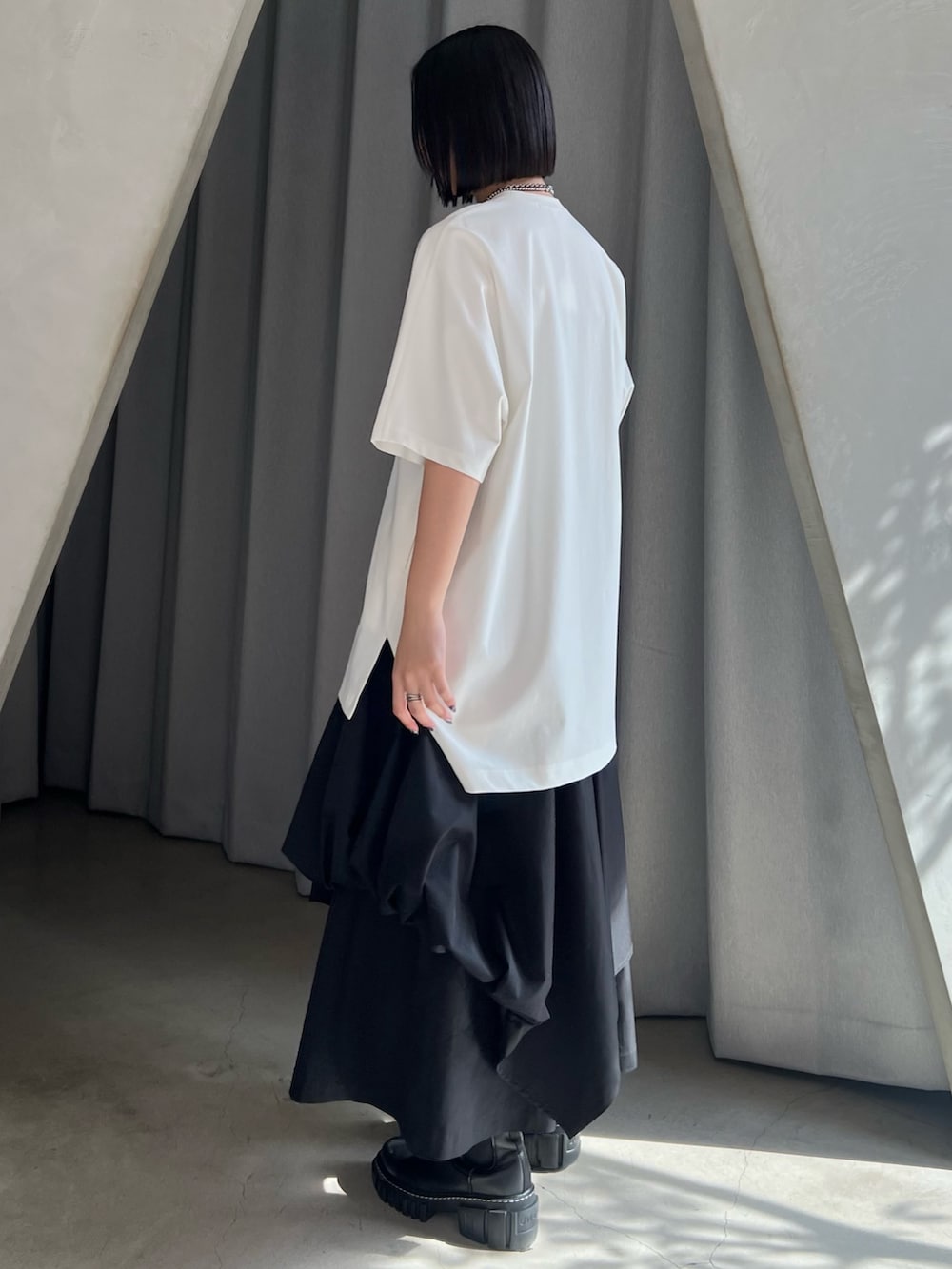 ホワイト系のTシャツ/カットソー、ブラック系のその他パンツ、ブラック系のブーツを着用したレディースの春コーディネートの2枚目の写真