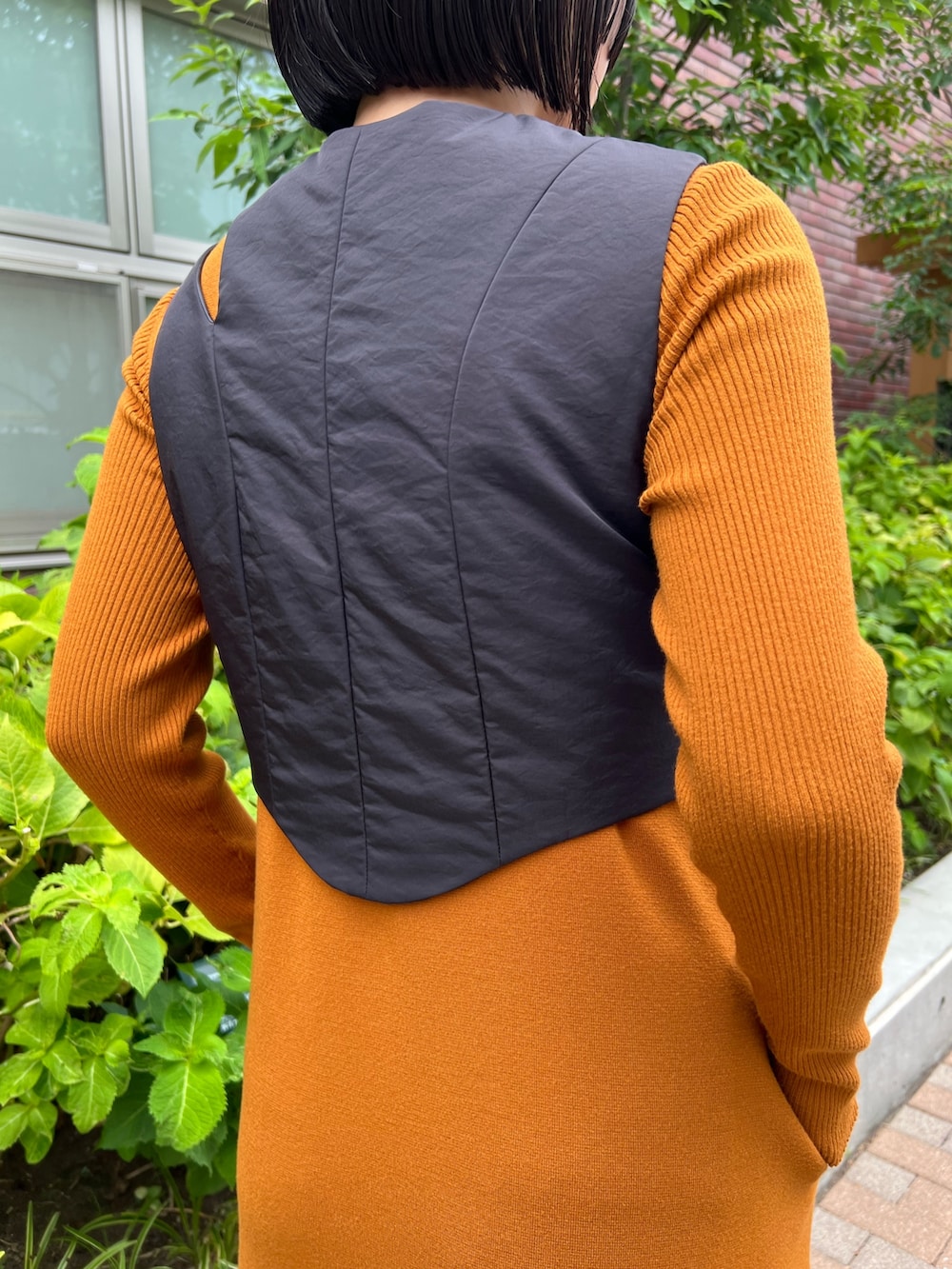 ブラック系のその他トップス、イエロー系のワンピース、ブラック系のブーツを着用したレディースの秋コーディネートの6枚目の写真