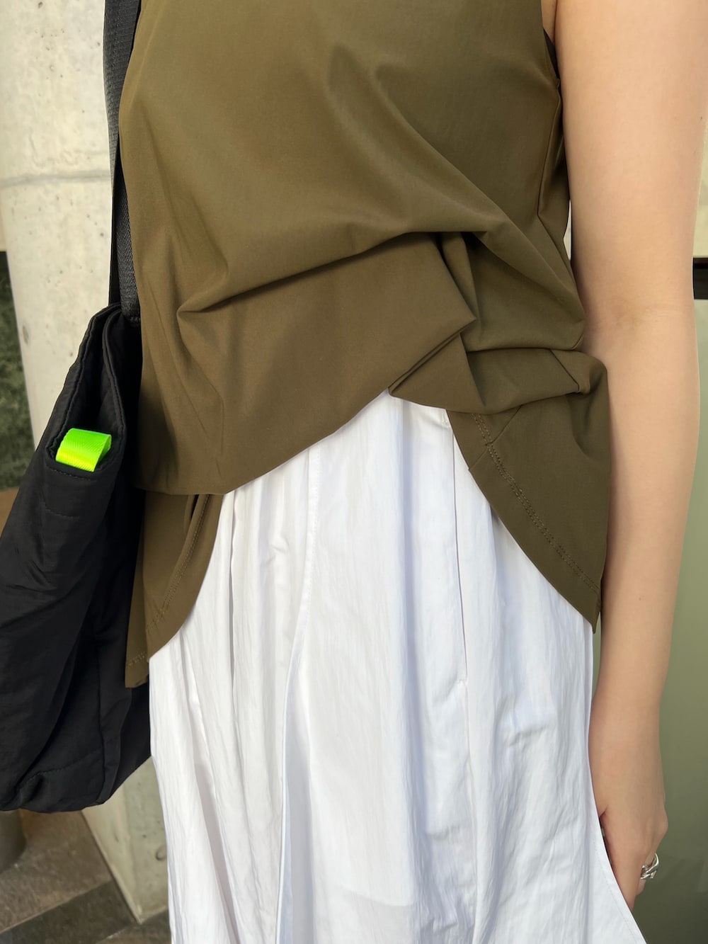 ホワイト系のワンピース、ブラック系のトートバッグ、シルバー系のサンダルを着用したレディースの春コーディネートの4枚目の写真