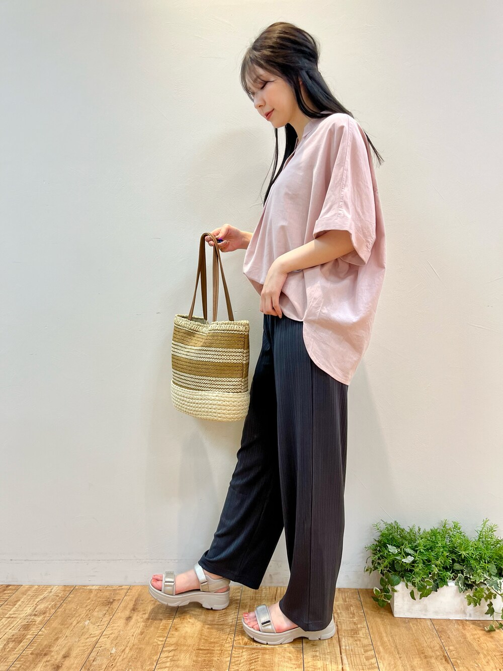 ピンク系のシャツ/ブラウス、グレー系のその他パンツ、イエロー系のトートバッグを着用したレディースの春コーディネートの2枚目の写真