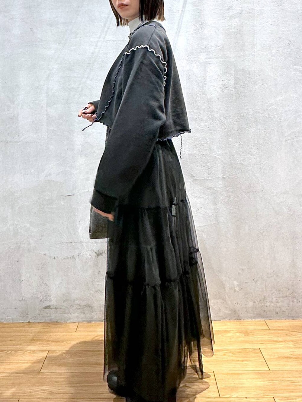 ホワイト系のTシャツ/カットソー、ブラック系のトートバッグ、ブラック系のスカートを着用したレディースの冬コーディネートの6枚目の写真