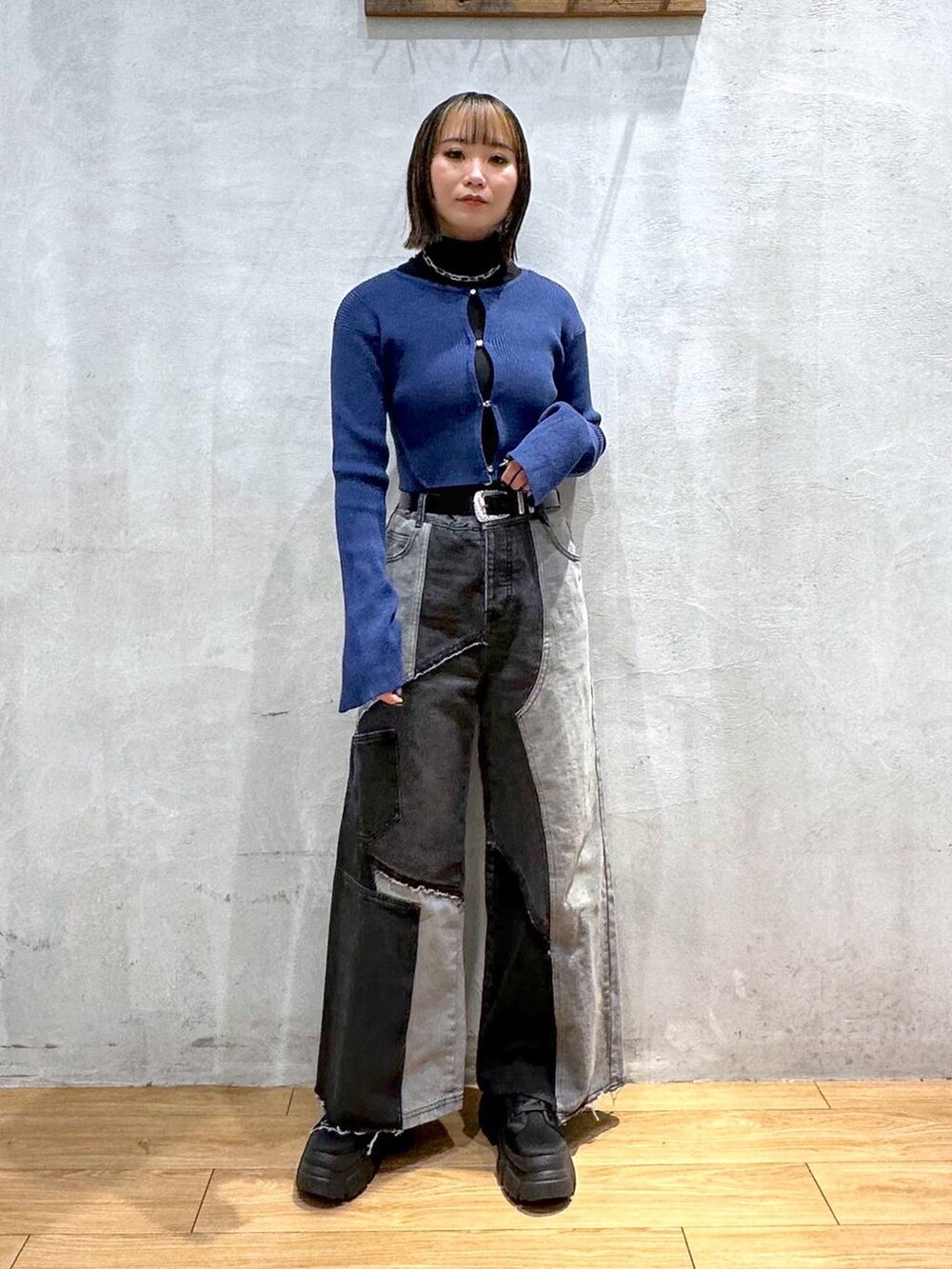 ブラック系のブーツ、ブルー系のニット/セーター、ブラック系のデニムパンツを着用したレディースの冬コーディネートの3枚目の写真