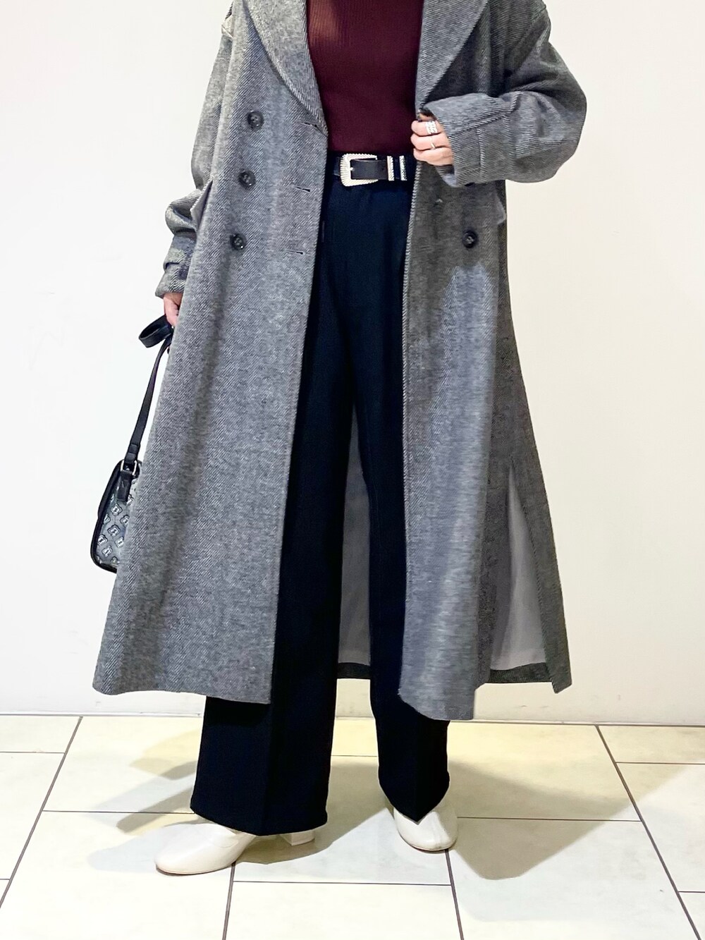 ブラウン系のニット/セーター、ブラック系のその他アウター、ブラック系のスラックスを着用したレディースの冬コーディネートの4枚目の写真