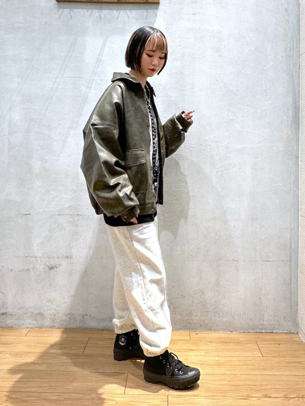 ブラウン系のブルゾン、グレー系のスウェットパンツ、ブラック系のニット/セーターを着用したレディースの秋コーディネートの3枚目の写真