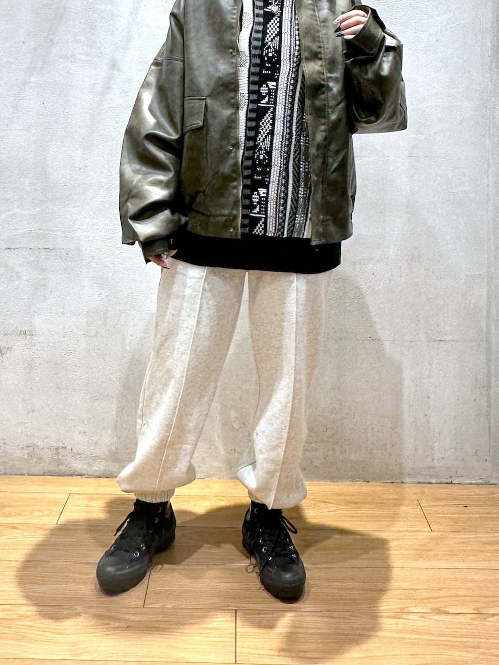 ブラウン系のブルゾン、グレー系のスウェットパンツ、ブラック系のニット/セーターを着用したレディースの秋コーディネートの5枚目の写真