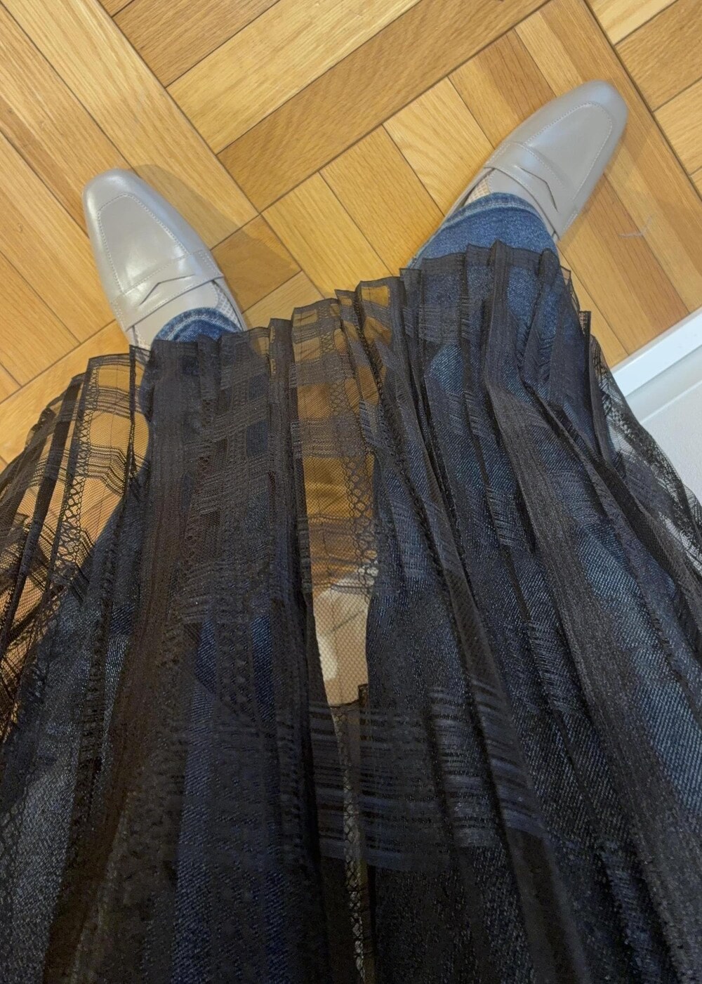 ブラック系のスカート、ベージュ系のボストンバッグ、グレー系のローファーを着用したレディースの春コーディネートの5枚目の写真