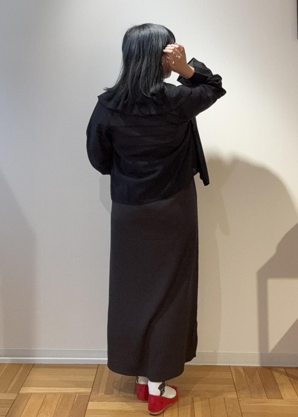 グレー系のワンピース、ブラック系のシャツ/ブラウス、ホワイト系のニット/セーターを着用したレディースの春コーディネートの2枚目の写真