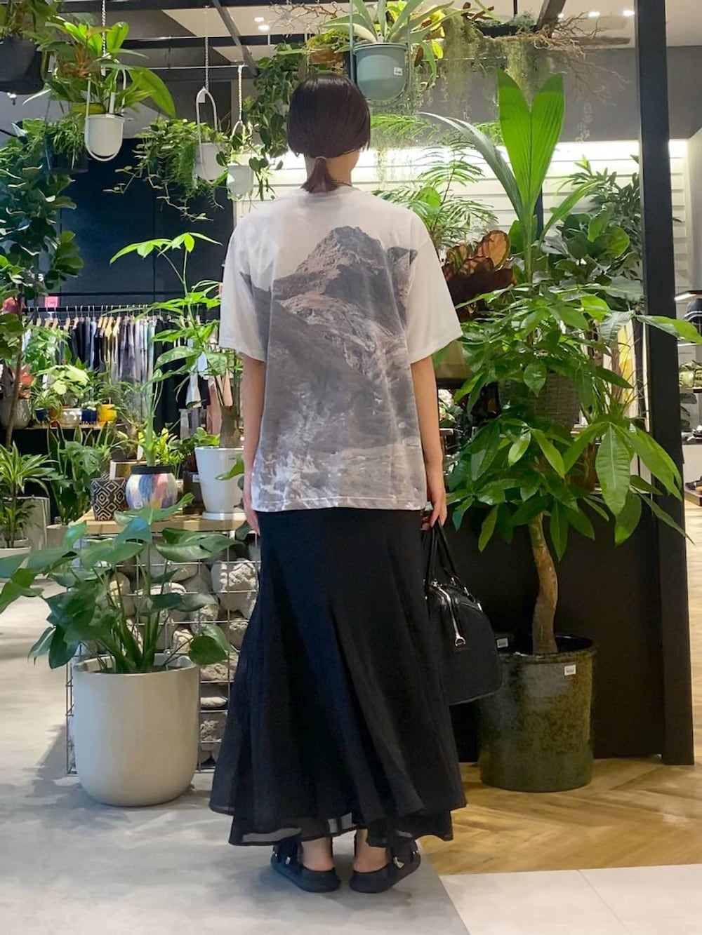 ブラック系のサンダル、グレー系のTシャツ/カットソー、ブラック系のスカートを着用したレディースの夏コーディネートの4枚目の写真