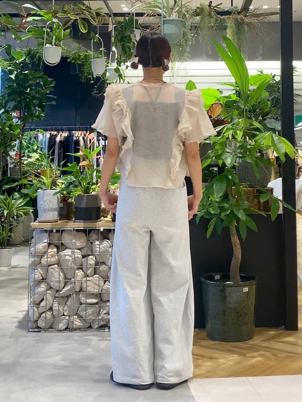 ブラック系のショルダーバッグ、ブラック系のサンダル、グレー系のスウェットパンツを着用したレディースの夏コーディネートの4枚目の写真