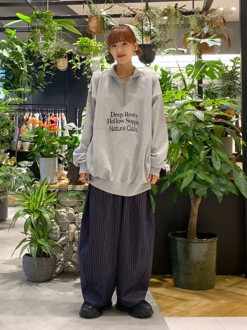 ブラック系のショルダーバッグ、ブラック系のローファー、ブルー系のスラックスを着用したレディースの秋コーディネートの6枚目の写真