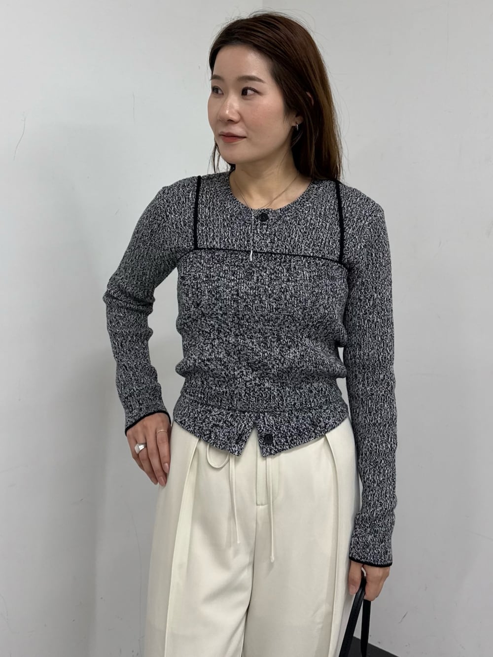 ブラック系のカーディガン/ボレロ、ホワイト系のその他パンツ、ブラック系のショルダーバッグを着用したレディースの冬コーディネートの5枚目の写真