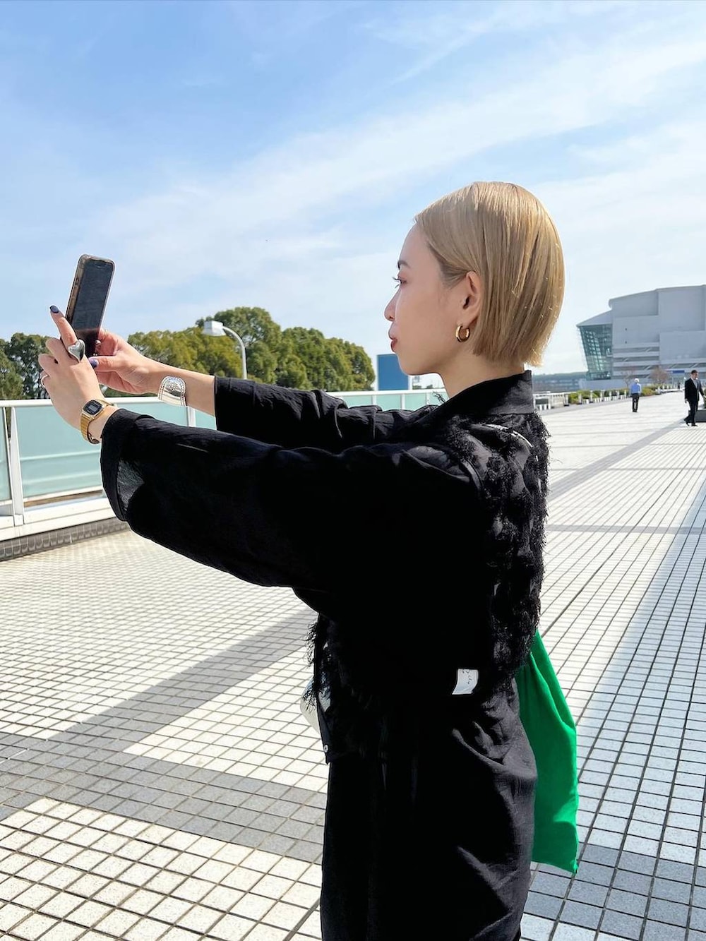 シルバー系のサンダル、ブルー系のデニムパンツを着用したレディースの春コーディネートの3枚目の写真