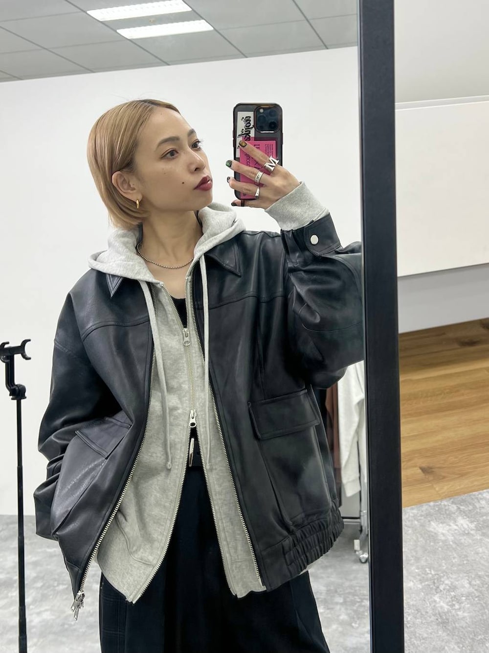 ブラック系のブーツ、ブラック系のスラックス、ブラック系のブルゾンを着用したレディースの秋コーディネートの3枚目の写真