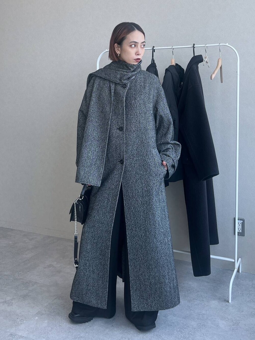 ブラック系のハンドバッグを着用したレディースの秋コーディネートの2枚目の写真