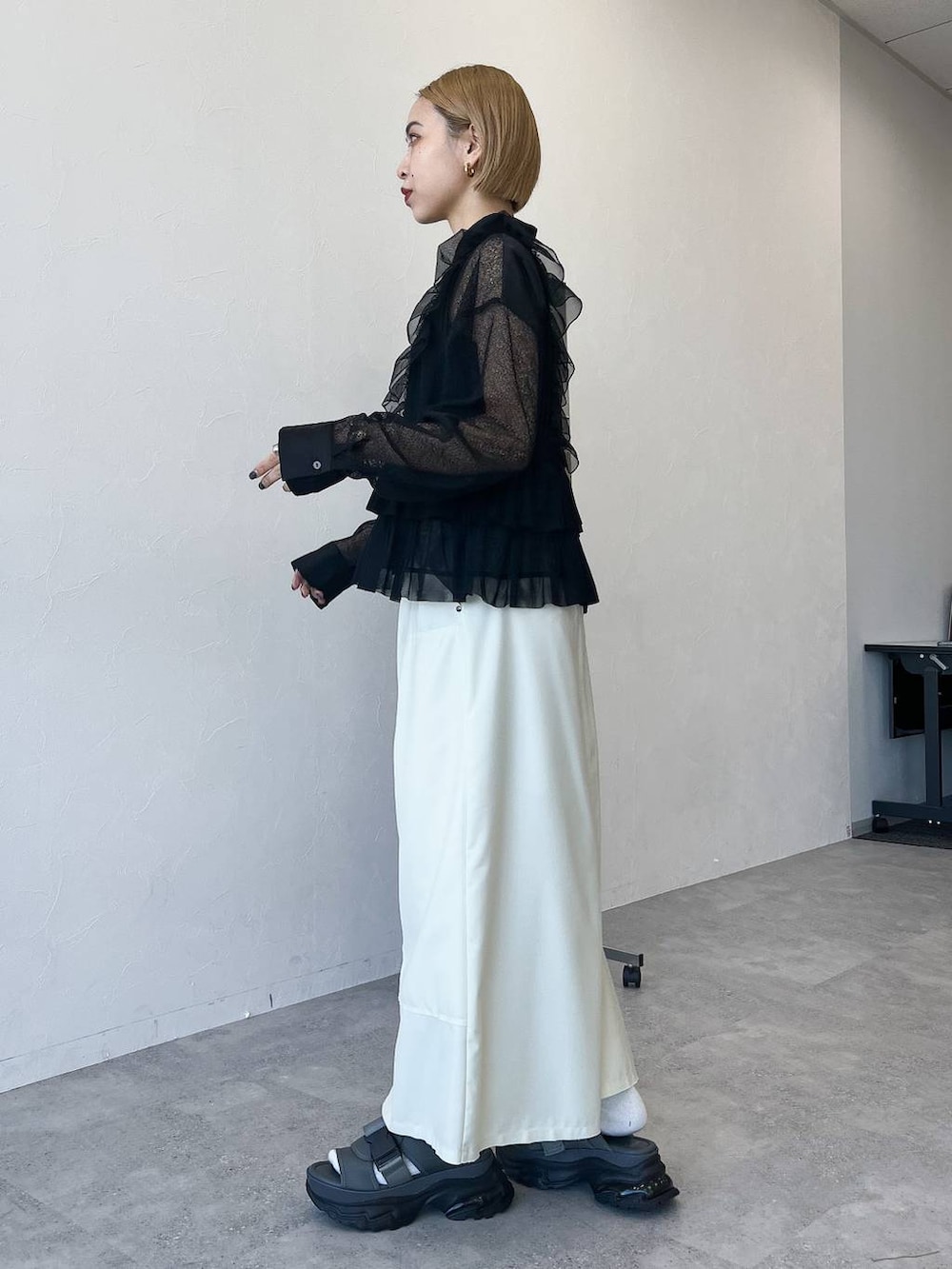 ブラック系のベスト、ブラック系のシャツ/ブラウス、ホワイト系のスカートを着用したレディースの春コーディネートの3枚目の写真