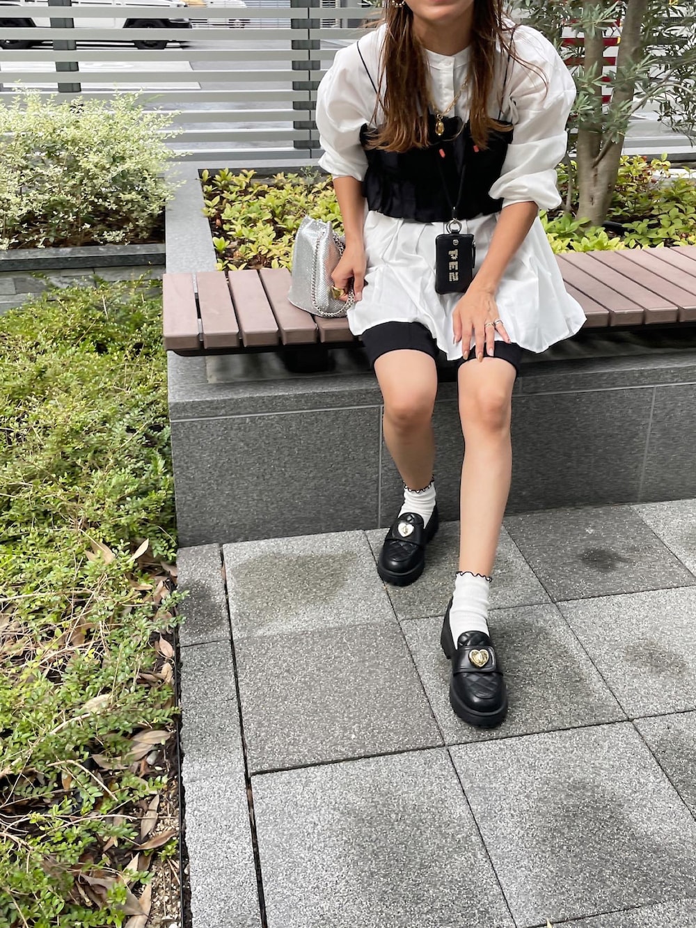 ブラック系のTシャツ/カットソー、ブラック系のその他パンツ、シルバー系のショルダーバッグを着用したレディースの秋コーディネートの2枚目の写真