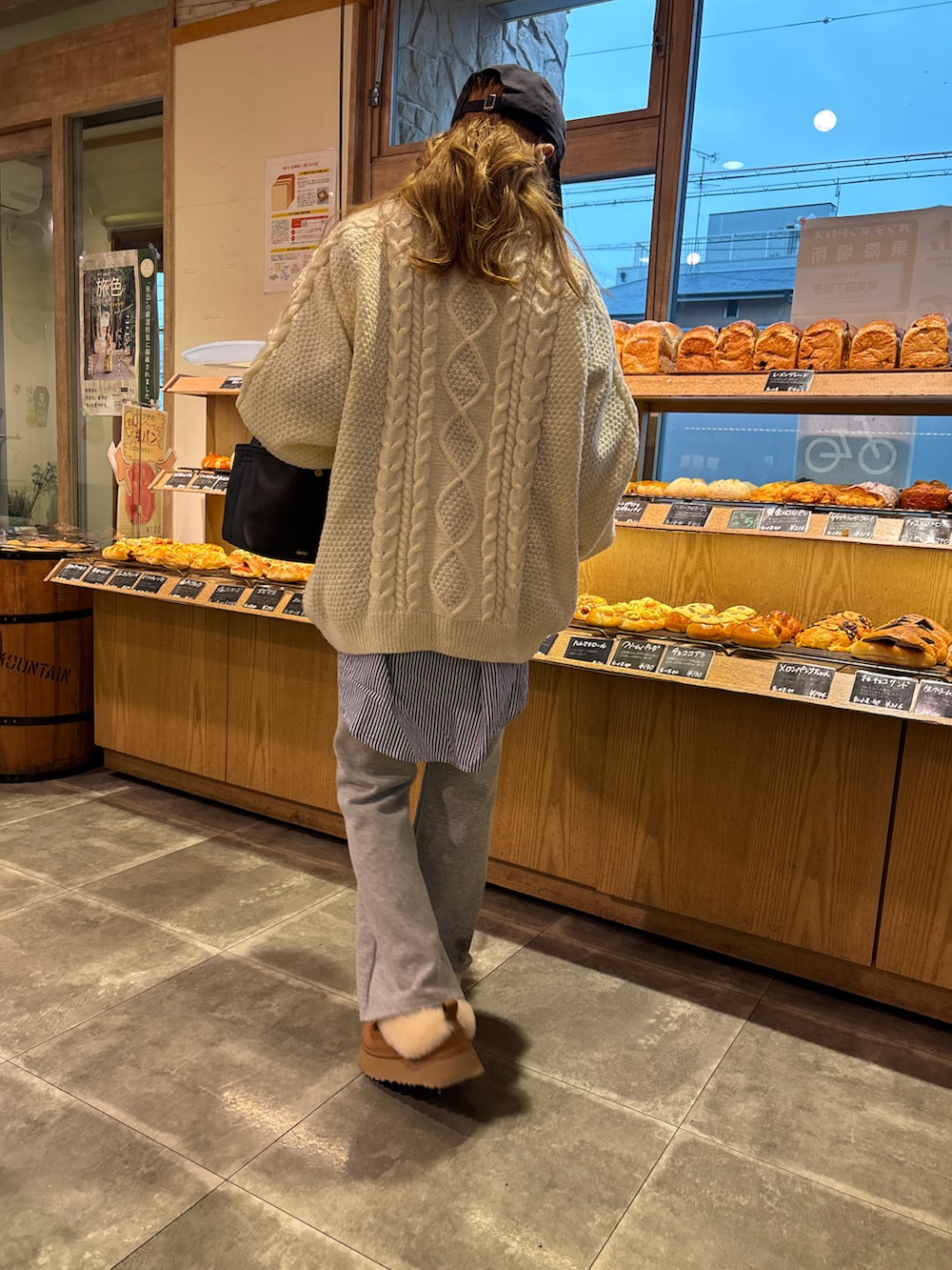 ホワイト系のニット/セーター、ブルー系のデニムパンツ、ブラウン系のブーツを着用したレディースの秋コーディネートの3枚目の写真