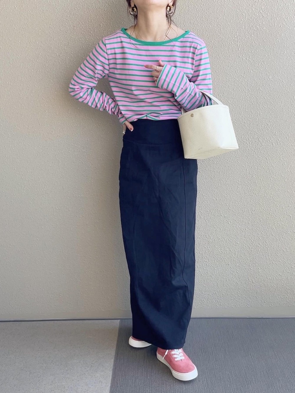 ピンク系のTシャツ/カットソー、ブラック系のスカート、ブルー系のデニムジャケットを着用したレディースの春コーディネートの2枚目の写真