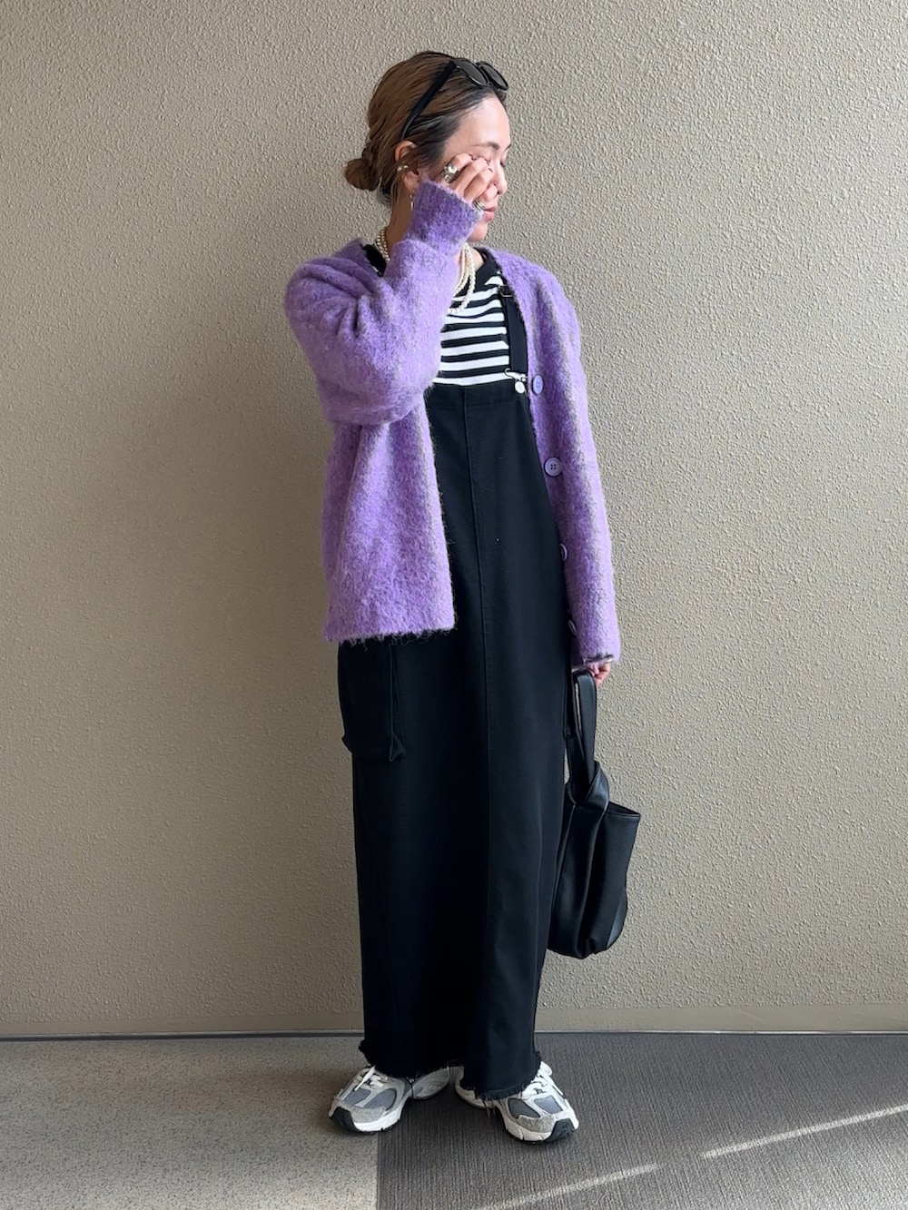 パープル系のカーディガン/ボレロ、ブラック系のTシャツ/カットソー、ブラック系のジャンパースカートを着用したレディースの秋コーディネートの2枚目の写真