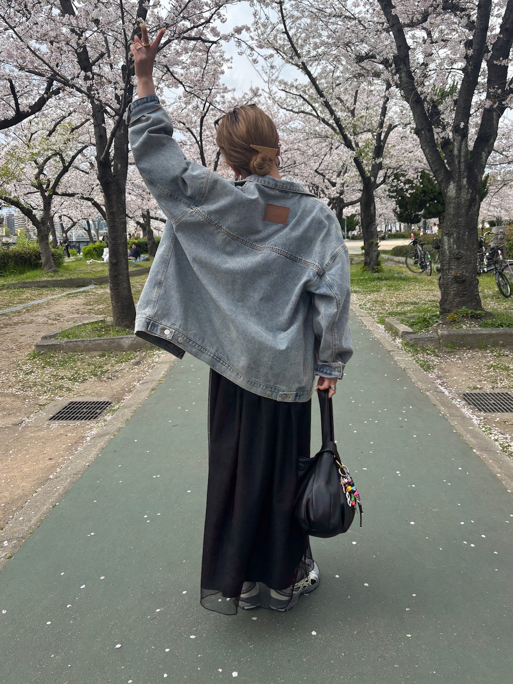 ホワイト系のTシャツ/カットソー、ブラック系のワンピース、ブルー系のデニムジャケットを着用したレディースの春コーディネートの5枚目の写真