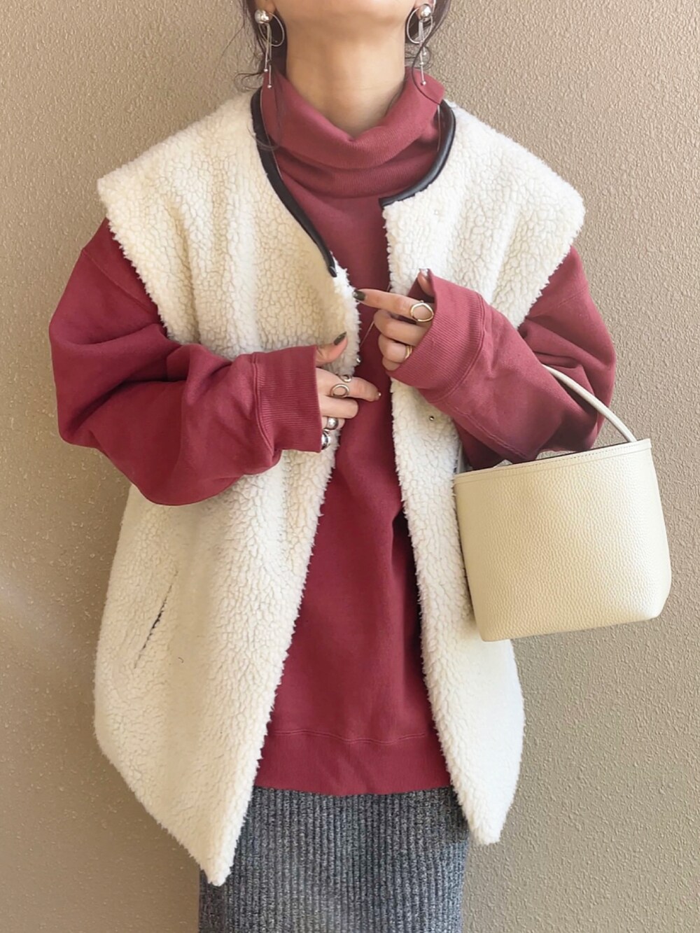 レッド系のスウェット、ブラック系のスカート、シルバー系のピアス（両耳用）を着用したレディースの秋コーディネートの2枚目の写真