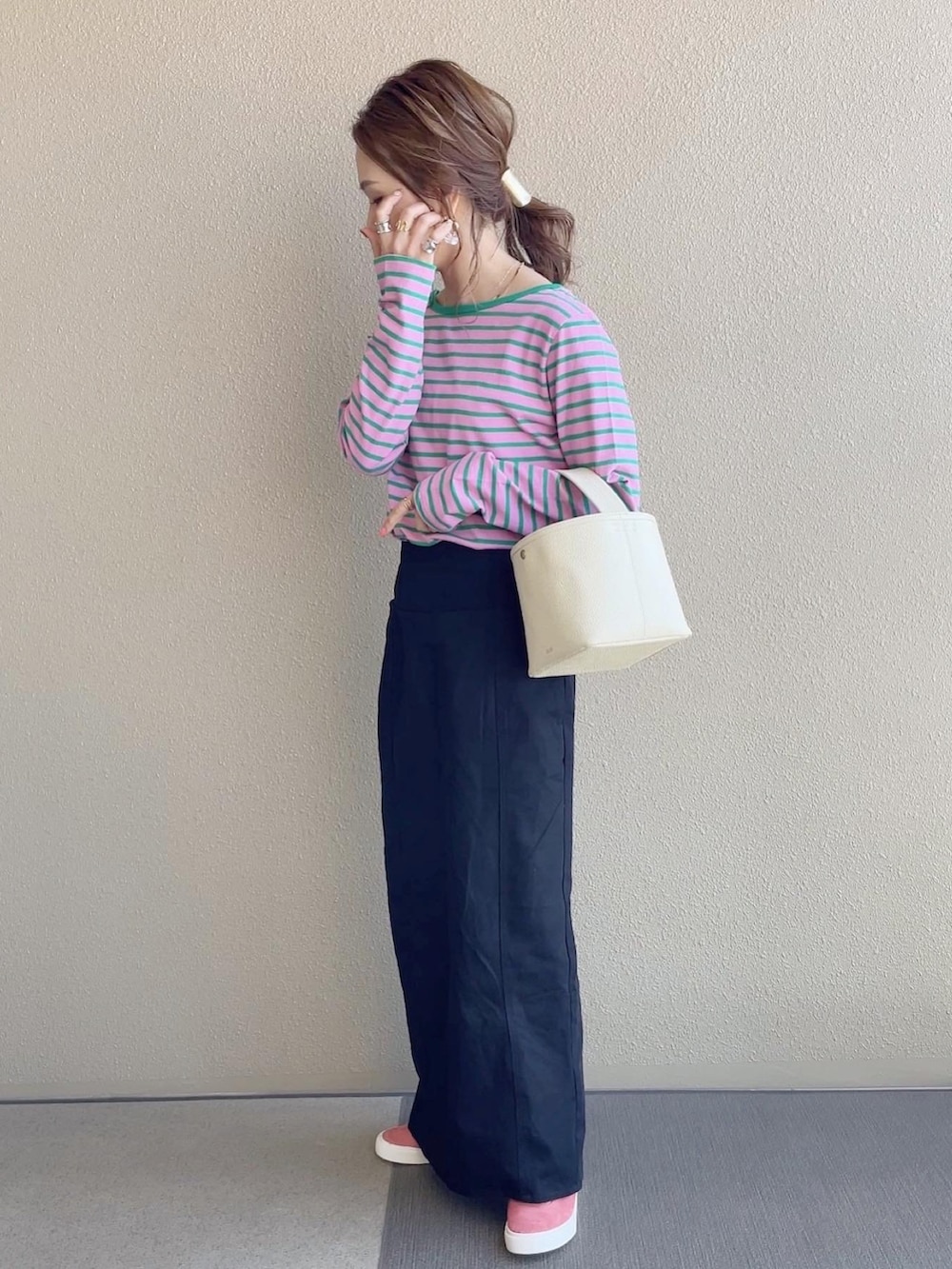 ピンク系のTシャツ/カットソー、ブラック系のスカート、ブルー系のデニムジャケットを着用したレディースの春コーディネートの3枚目の写真