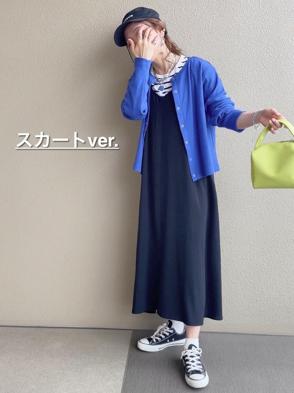 ブルー系のカーディガン/ボレロ、ブルー系のデニムパンツ、ブラック系のワンピースを着用したレディースの春コーディネートの3枚目の写真