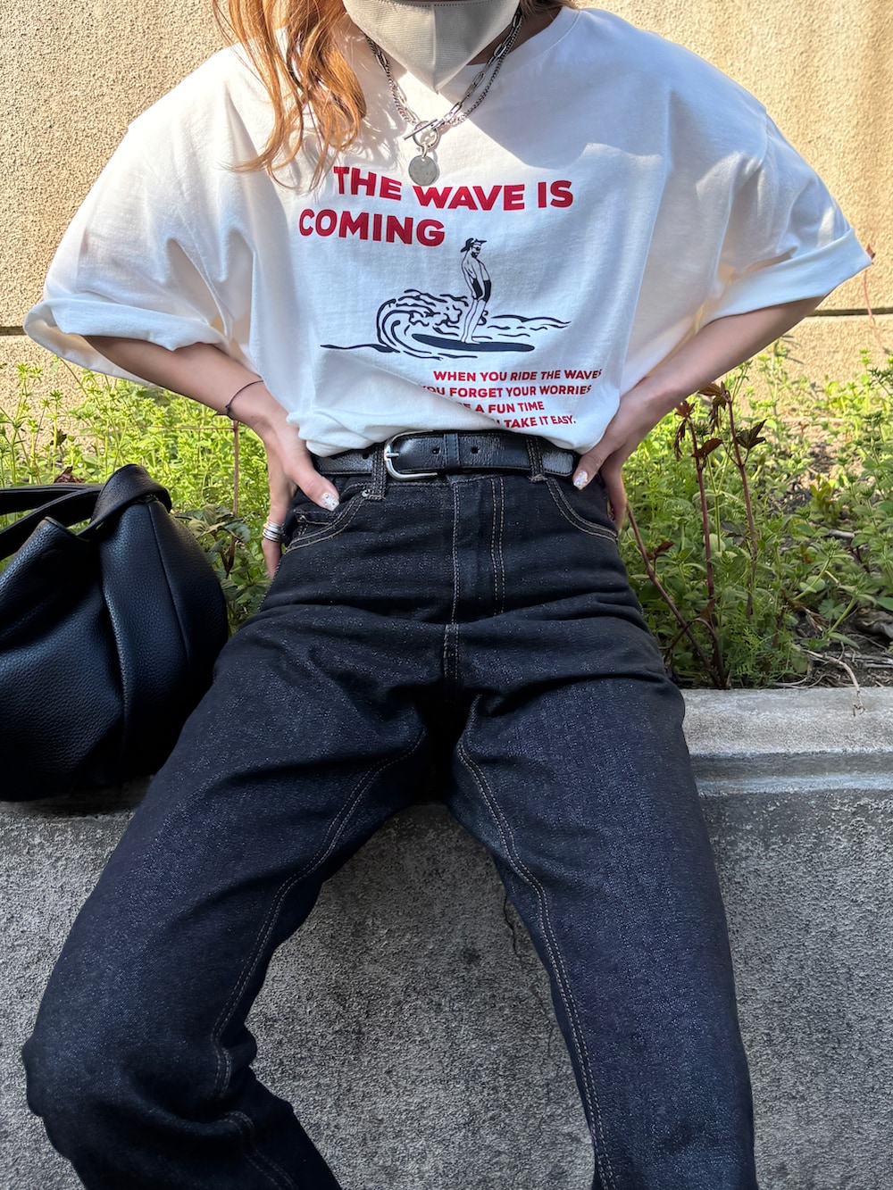 ブラック系のデニムパンツ、ホワイト系のTシャツ/カットソーを着用したレディースの春コーディネートの3枚目の写真