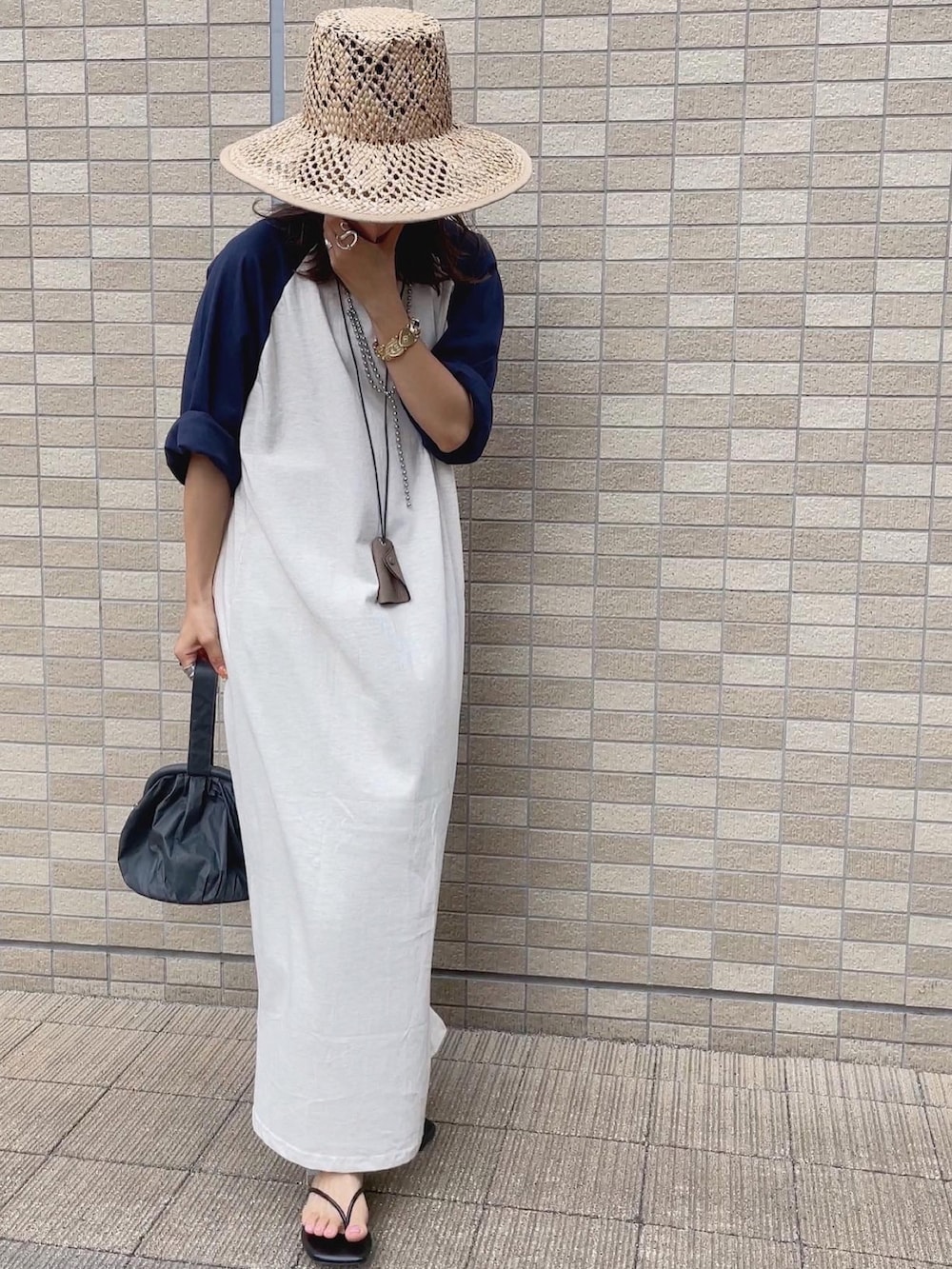 オレンジ系のシャツ/ブラウス、ベージュ系のハットを着用したレディースの夏コーディネートの4枚目の写真