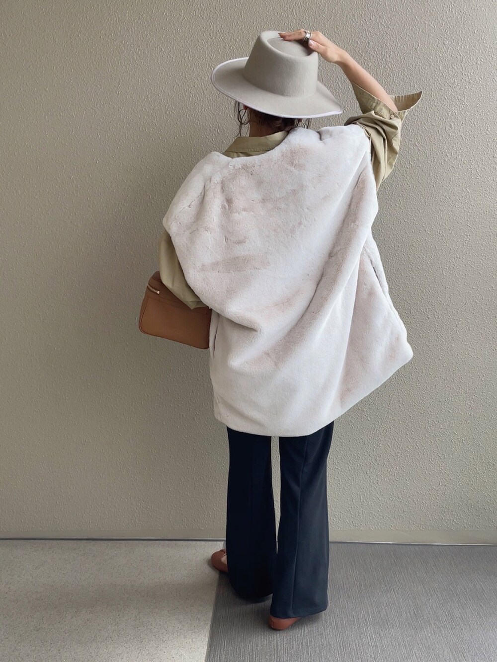 ホワイト系のベスト、ベージュ系のシャツ/ブラウス、ブラック系のスラックスを着用したレディースの秋コーディネートの3枚目の写真