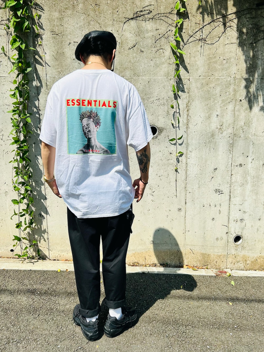 ブラック系のスニーカー、ホワイト系のTシャツ/カットソー、ブラック系のパンツを着用したメンズの夏コーディネートの3枚目の写真