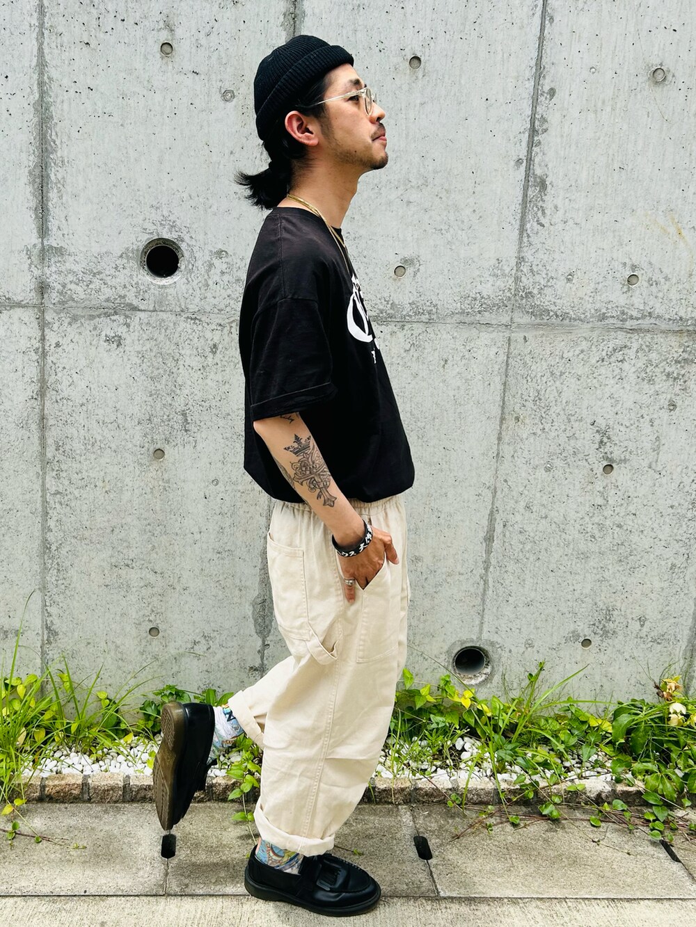 ブラック系のローファー、ホワイト系のカーゴパンツ、ブラック系のTシャツ/カットソーを着用したメンズの夏コーディネートの4枚目の写真
